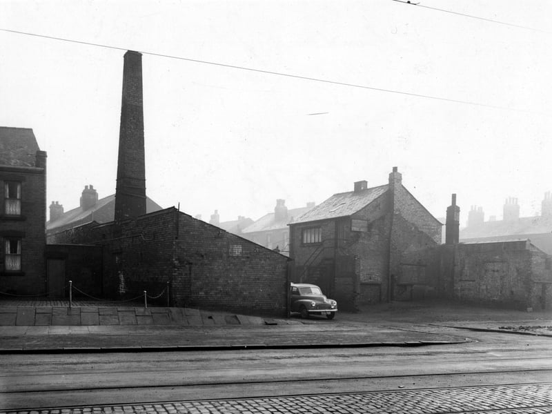Looking east across Balm Road at Robinsons Yard in December 1951. A car is parked in the entrance of the brick built premises, which have a large chimney attached, this chimney was formerly part of a pottery.