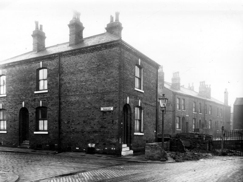 Cresent in December 1958. On the left is number 3, a through by light terraced house. Number 5, a back-to-back property is located in the gable end of the terrace. On the right, are some short walls, the remains of shared outside toilets. The terraced houses visible in the background on the left are numbers 1 to 33 Dane Street while on the right railings mark the start of the corporation yard.