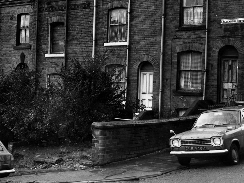 A row of three terraced houses on Alexandra Grove pictured in December 1972. On the right is Hartwell Road where a car, reg: CLB 948H is parked.