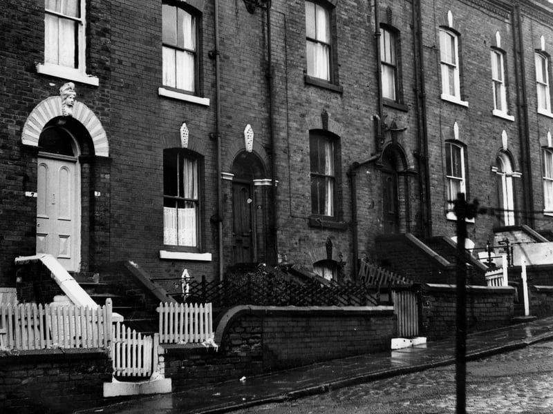 A row of back-to-back terraced houses o Alexandra Crescent each with a private front yard. Number 11 has been extended upwards using a dormer window. Pictured in December 1972.