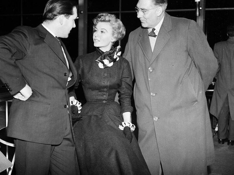 American actress Vera-Ellen welcomed to Turnhouse by Scottish entertainer Kenneth McKellar and Mr William Bird before her performance at the Roosevelt Memorial Polio Fund Hallowe'en Ball in October 1956.