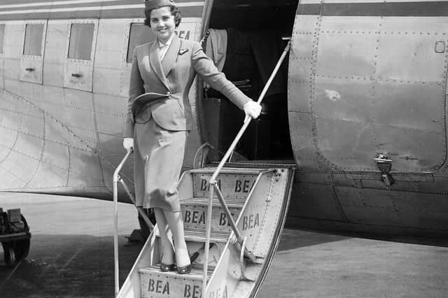 Jill Morgan, an air hostess with BEA (British European Airways), stands on the steps to her plane at Turnhouse Airport in June 1955.