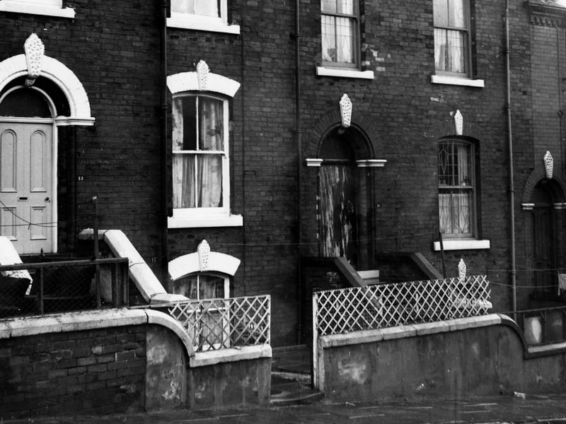 Two back-to-back terraced houses on Alexandra Grove each with a private garden. These houses are three stories and have steps leading down to the basement from the front yard. Pictured in December 1972.
