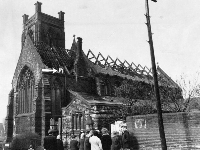 Fire devastated the Church of All Hallows with St. Simon in April 1970. The arrow indicates a firefighter who is removing loose slates from the roof.