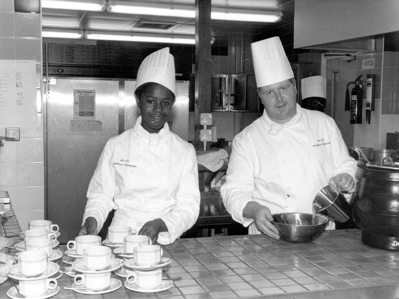 Staff in chef's whites working in the kitchen of Dr. B's Caribbean restaurant in December 1989.