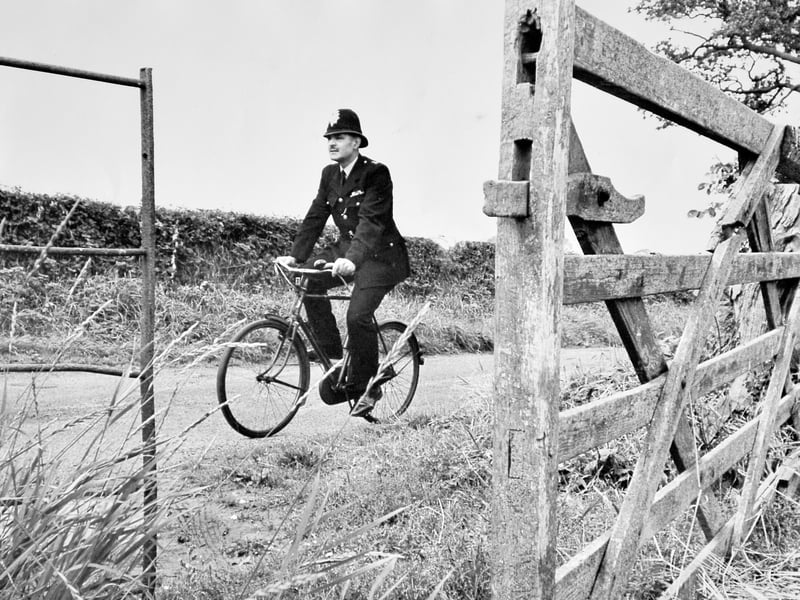 Police Constable Roy Duncalfe on patrol on his bicycle, September 14, 1965. He joined the police in 1946 and served in Market Drayton and Hodnet. In about 1968 he moved to North Road, Wellington, and was based at Wellington police station. He was said to be Shropshire's first dog handler and his dog Sultan was well known. PC Duncalfe retired in March 1974.