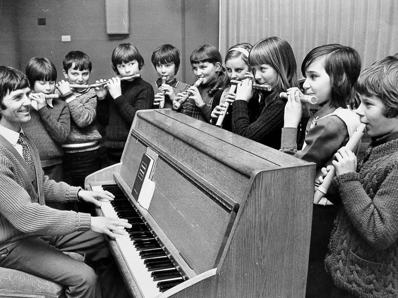 At the piano is Mr Roy Powell, deputy headmaster with fourth year pupils at Queenswood Junior School in Ketley Bank, on March 19, 1976, making music with home-made flutes and pipes.