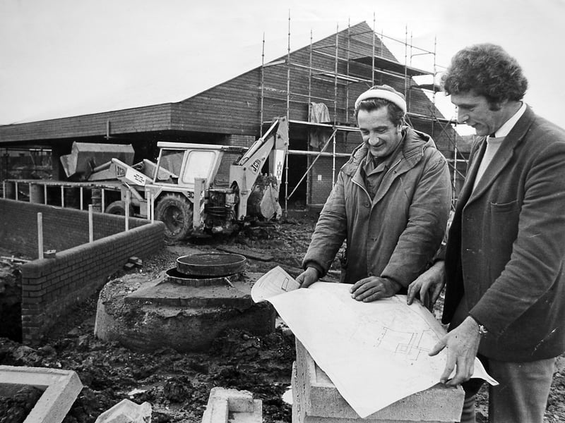 Work on the new Malinslee local centre in November 1976, t original caption reads: 'Site agent Mr Bob Caulcott (right) with Mr Denis Nash (foreman bricklayer) with the new Malinslee shopping centre in the background. The new centre, it is hoped, will be open before Christmas and cater for about 3,000 residents on the Malinslee estate.'