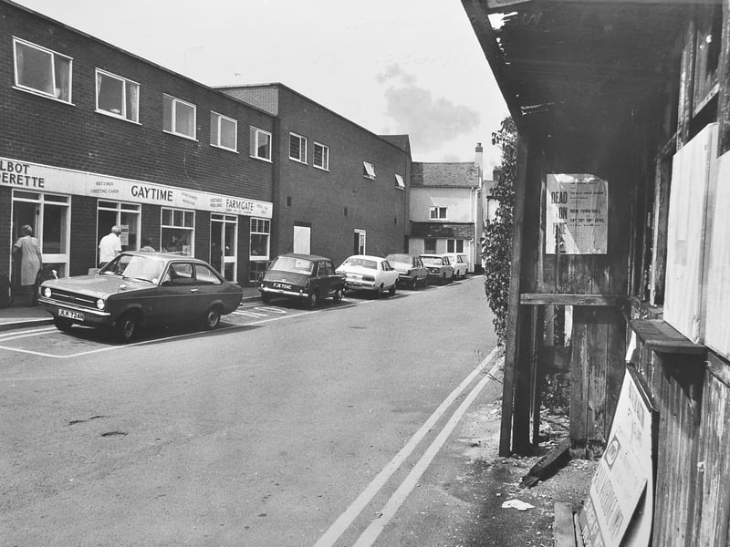 Cars parked at Wem on July 6, 1976. Visible business are Talbot Launderette, Gaytime, and Farmgate.