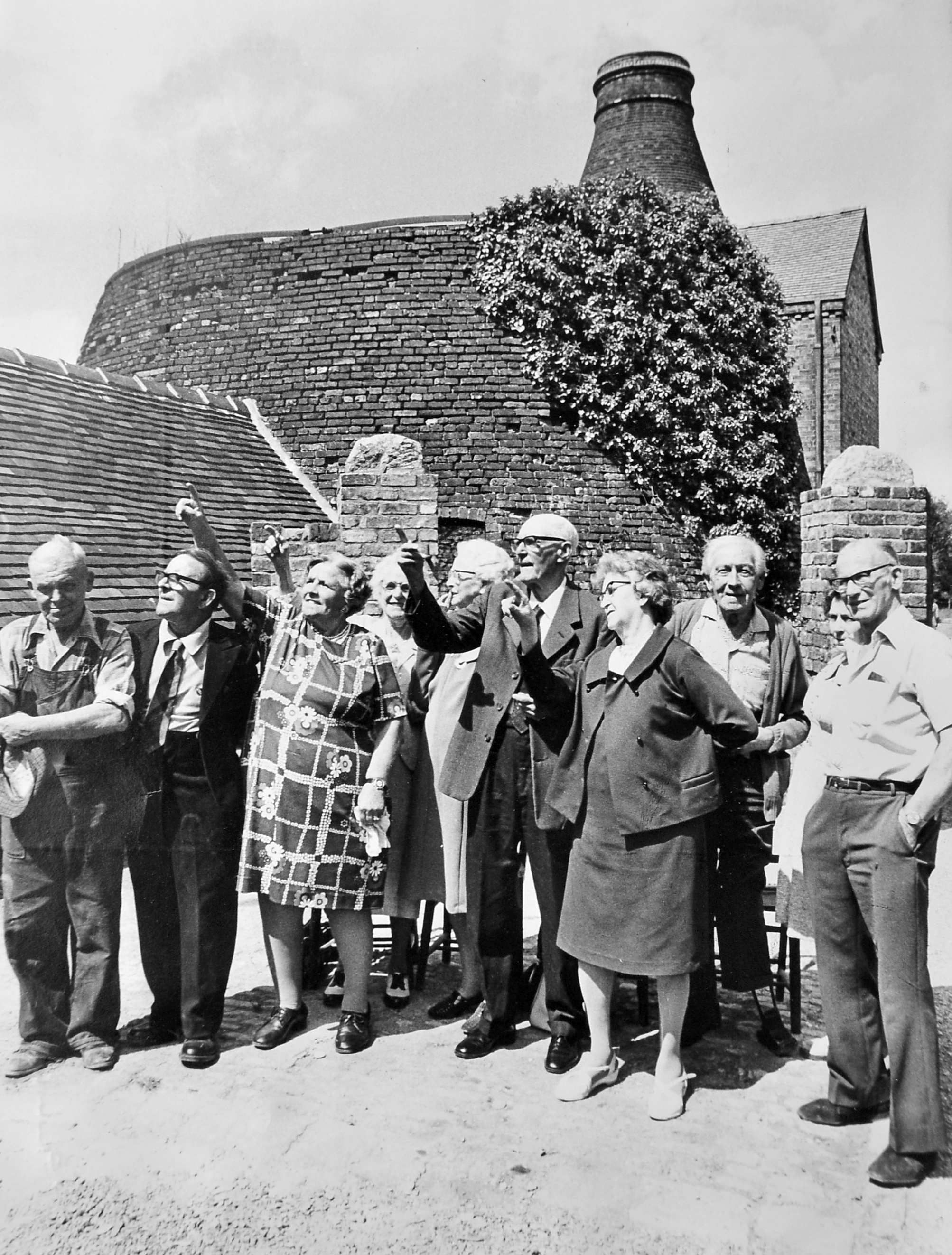 Former employees visit Coalport China Works on July 17, 1976. The original caption reads: 'Time to remember for ex-employees at the old Coalport Potteries, Telford. A gathering of retired workers met at the potteries on Saturday and are seen looking at the renovated workings during their visit.' 
