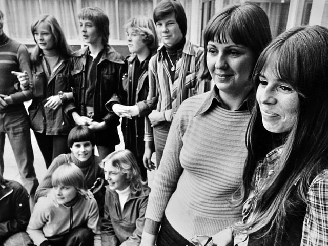 'Teachers Fraulein Moneka Spellmeyer (left) and Frau Ilka Dibbert with some of the pupils they have brought over to the Grove School, Market Drayton, on an exchange visit. The 11 girls and four boys in the German party are from a school at Lubeck. They are staying in local homes. Next year a party from the Grove School is to visit Lubeck.' October 1976.