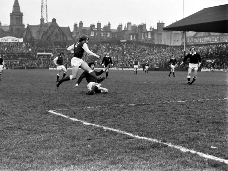 Hearts take on Hibs at Tynecastle in the Edinburgh derby in March 1976. Arthur Duncan is pictured on his way to a Hibs goal.