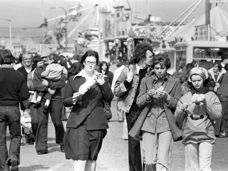 Three girls enjoy the Easter sunshine and some candy floss at the Links market funfair in Kirkcaldy, Fife, in April 1976