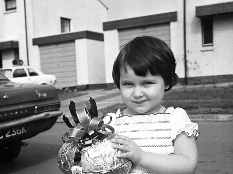 Two-year-old Anna Sansom with her Easter egg, the prize for being the 25,000th resident to move into Livingston new town, in April 1976