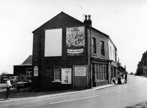 Looking south along Main Street in July 1975. To the right a group of children are gathered outside Archer's paper shop.