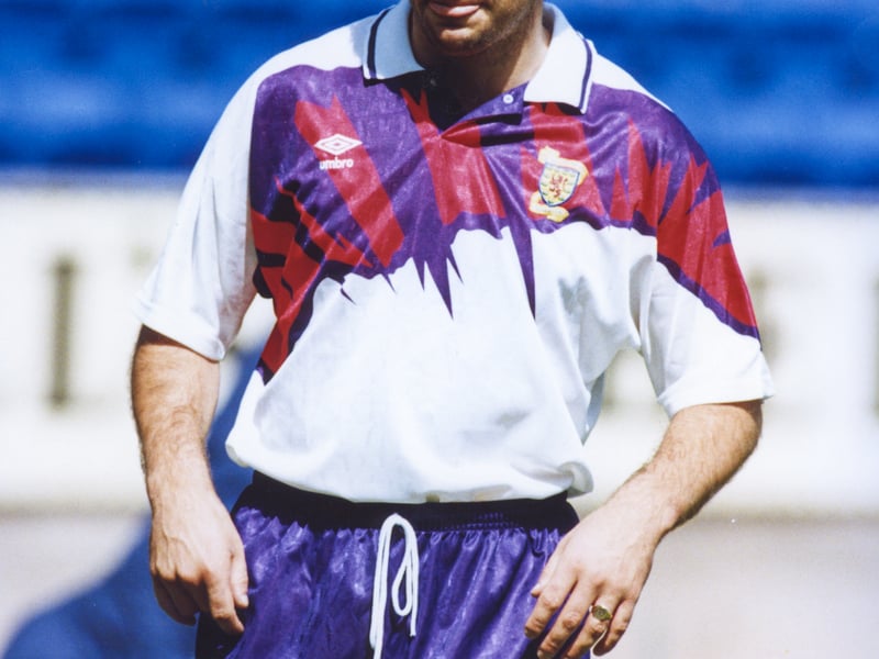 As you can see from the photo of Ally McCoist donning the jersey above, this effort from Umbro is peak early 1990's fashion. Almost shellsuit-like in its design, the purple and red design across the chest booms out amongst the striking white. It shouldn't work, but it somehow it does.
