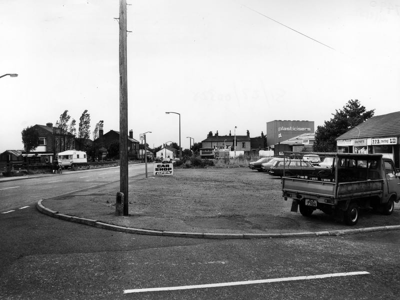 Looking north-east along Whitehall Road from the junction with Whitehall Grove in August 1981. On the right is a row of shops which include P.P.B. Racing Ltd., Carparts and Chinese Food takeaway. Further along are Whitehall Tyres and Plasticisers Ltd.