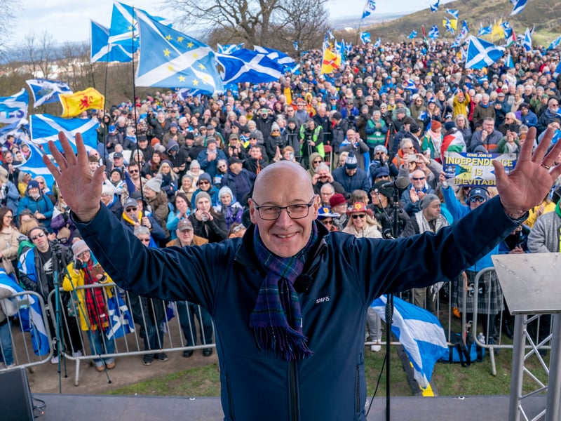 First Minister John Swinney on stage after speaking at the rally