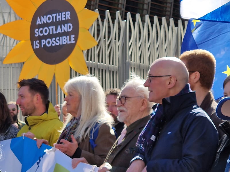 John Swinney, with Brian Cox, as the march passes the Scottish Parliament