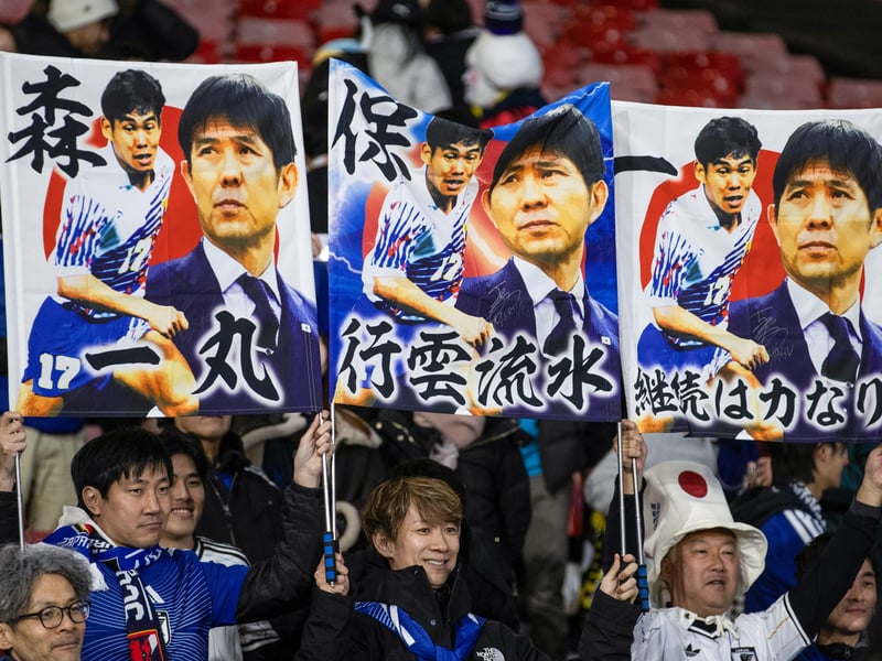 The Japanese fans hold up a banner of head coach Hajime Moriyasu.