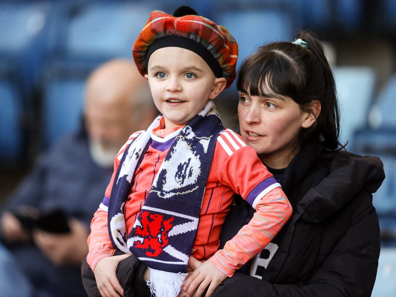 A young Scotland fan takes in the game with his parents ahead of kick-off.