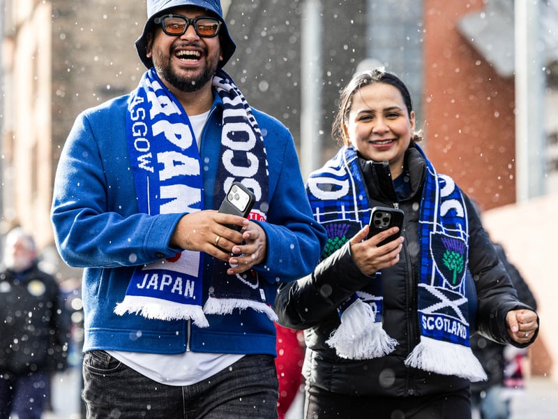 Scotland fans ahead of kick-off aren't deterred by the rain.