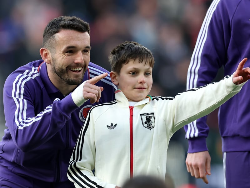 John McGinn of Scotland gestures with his mascot prior to kick-off.