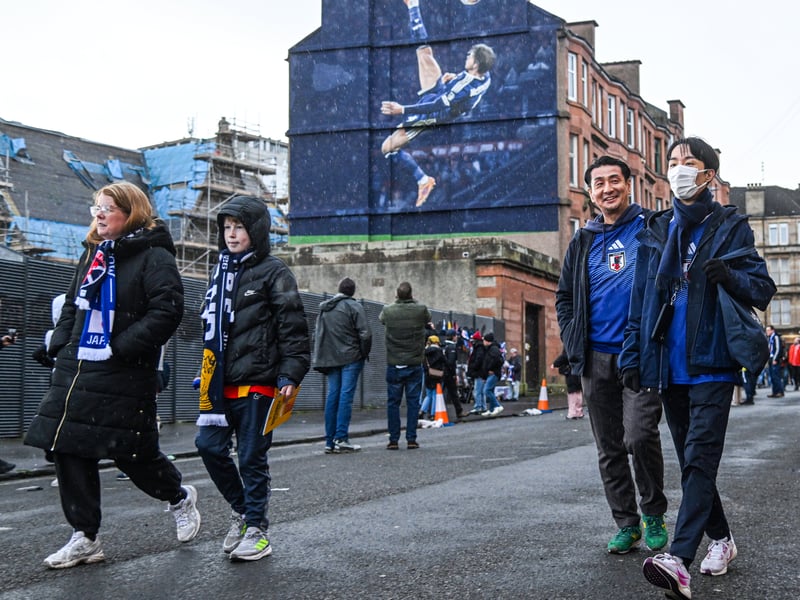 Fans pass the Scott McTominay mural as they walk to Hampden.