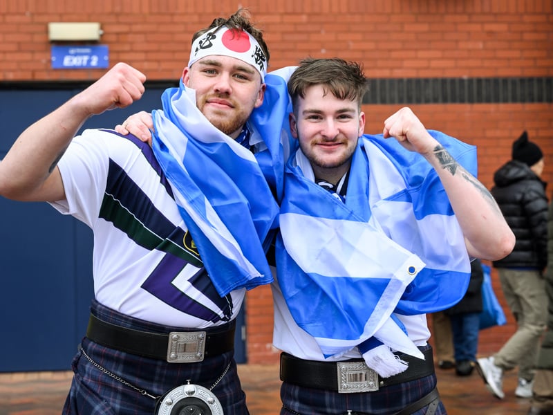Two fans in kilts prepare for the game with Japan.