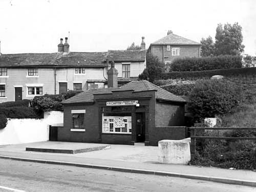 Pudsey Road Fisheries, a small one storey building run by H. Carter. The windows are leaded with patterns and the times of opening are shown on the left. Behind the fisheries can be seen on a row of terraced houses numbers 162 to 168 Gamble Hill. Pictured in May 1968.