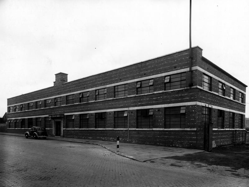 Premises of Hudswell, Clarke and Co engineering specialists, of 96 Jack Lane. The building is brick built, two storey with rows of windows on each floor. A car is parked outside the main entrance. There is a works entrance to the right. Pictured in March 1943.