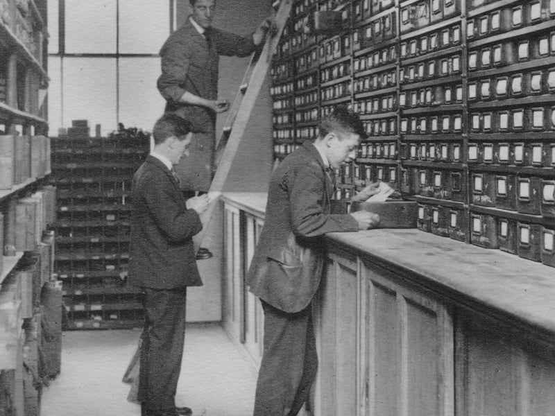 Employees of the Leeds Meter Company in a storeroom corner.