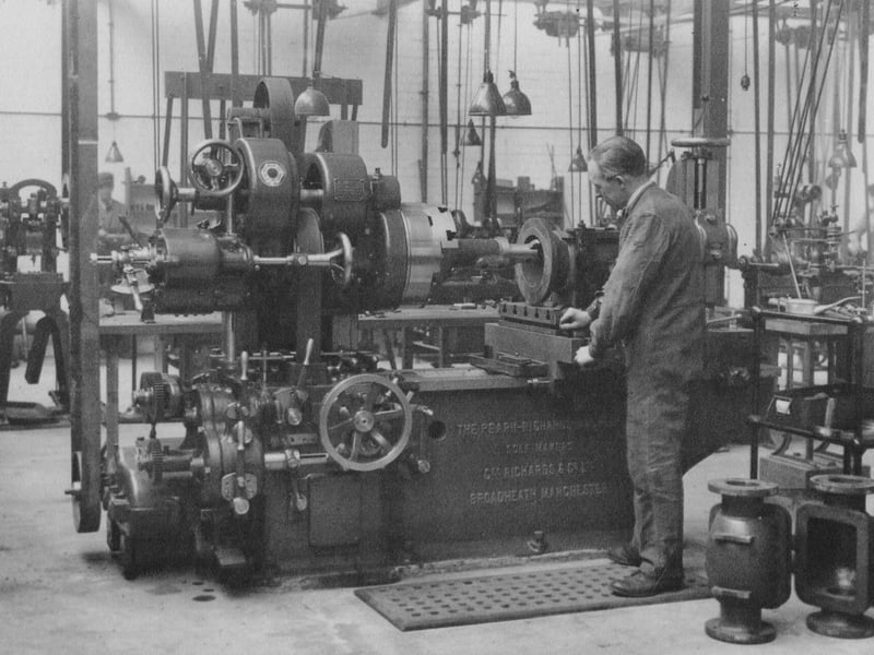 An employee of the Leeds Meter Company boring meter bodies.