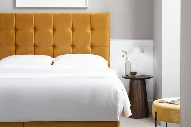 The Simba Hoxton bed in mustard velvet features a bold padded headboard and contemporary design finish