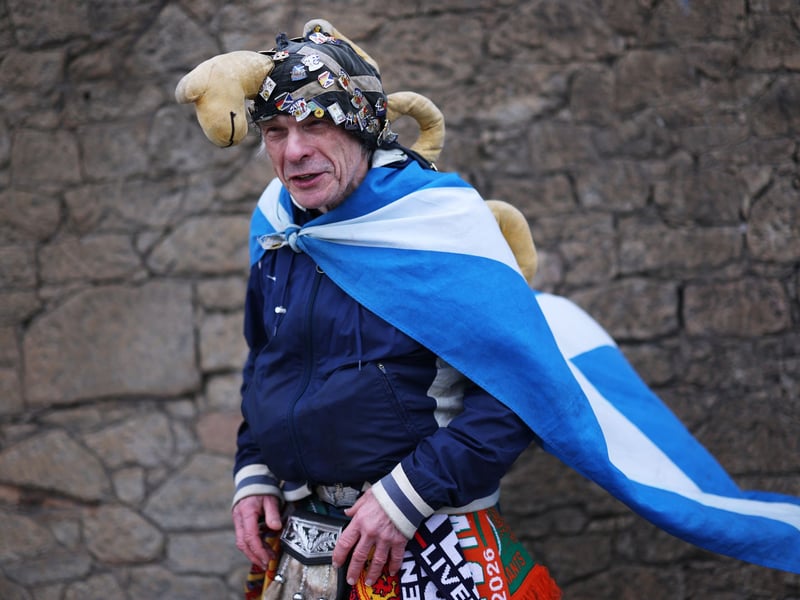 A Scotland fan with a Loch Ness monster hat is seen outside the stadium.
