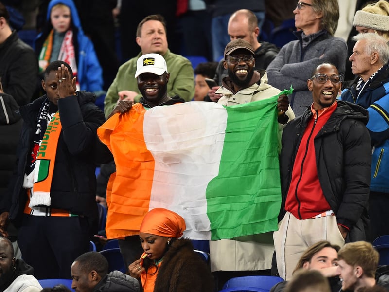 Ivory Coast fans display their national flag ahead of the game against Scotland.