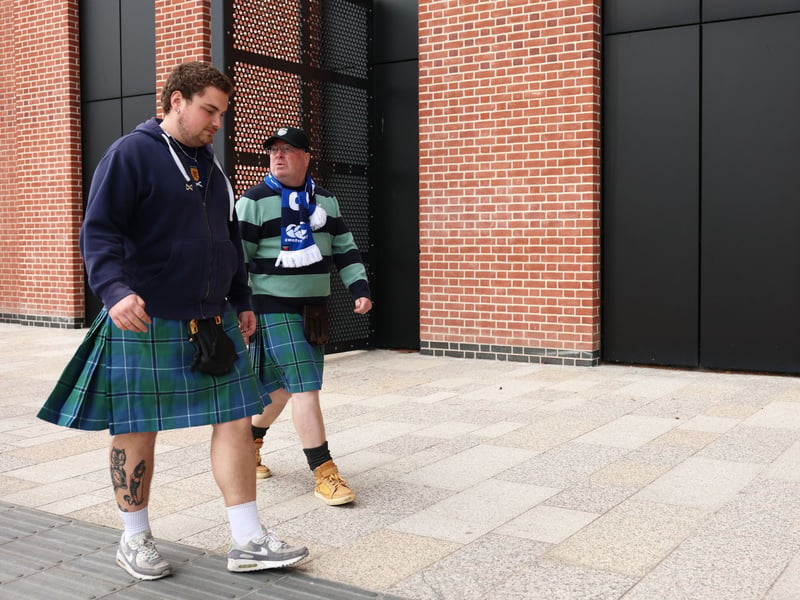 Scotland fans wearing kilts arrive at the stadium.