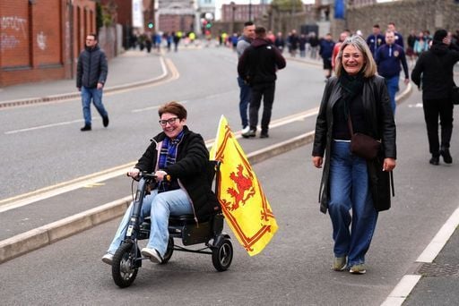 Two Scotland fans make their way to the main entrance at the Hill Dickinson Stadium.