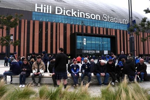 Fans sit outside the Hill Dickinson Stadium ahead of Scotland's game with Ivory Coast.