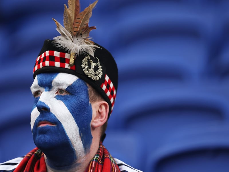 A Scotland fan with a painted face waits for the game to gt underway at the Hill Dickinson Stadium.