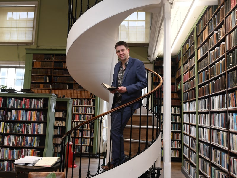Ian Harker stands on a fully functional spiral staircase that dates right back to the 1800s.