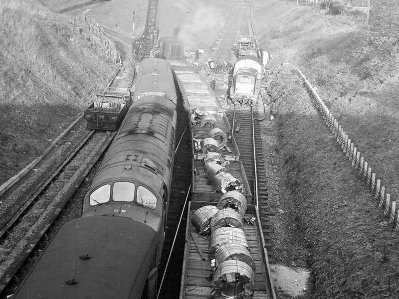 Workmen clearing up the wreckage of a diesel freight train after it crashed into an embankment near Craiglockhart station in October 1964.