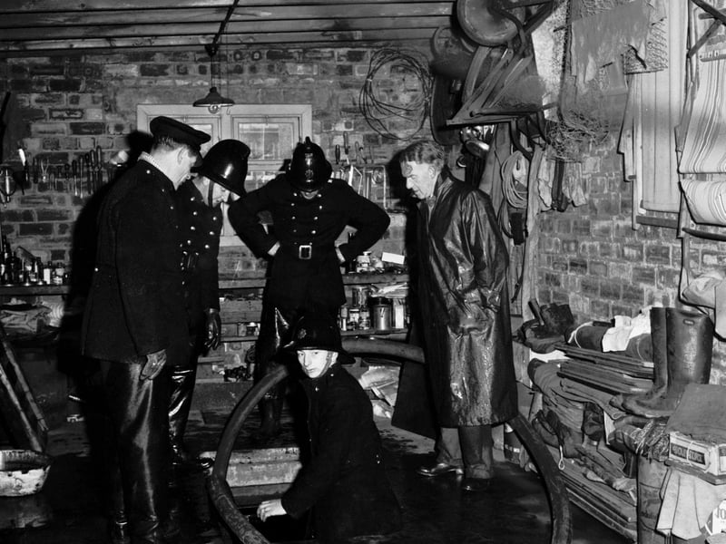 Firemen pump out a flooded garage after a water main burst in Craiglockhart Drive in November 1965.
