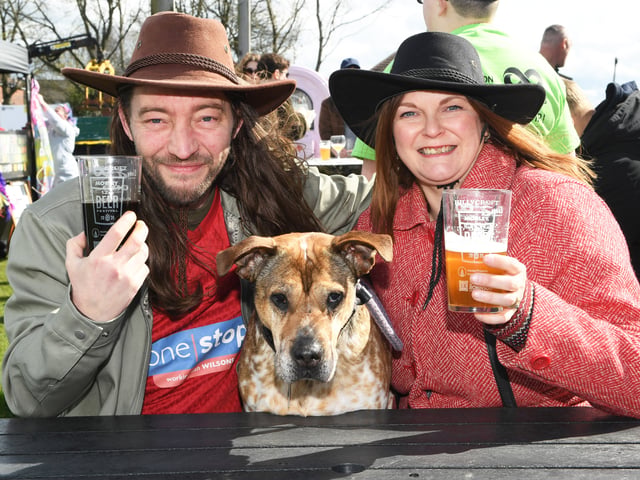 Nick and Louise Thatcher and Olga the dog enjoy a drink at the festival