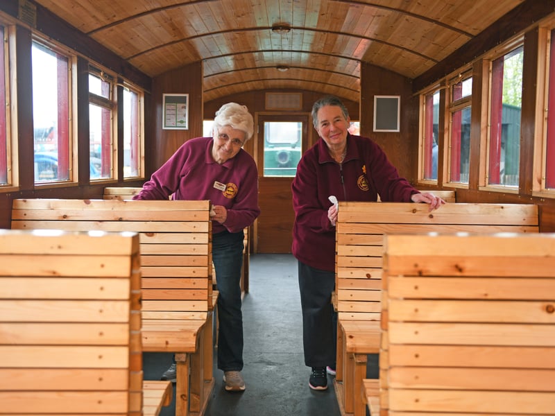 Volunteers Janet Auckland and Fran Bailey cleaning the carriage before the first passengers arrive.