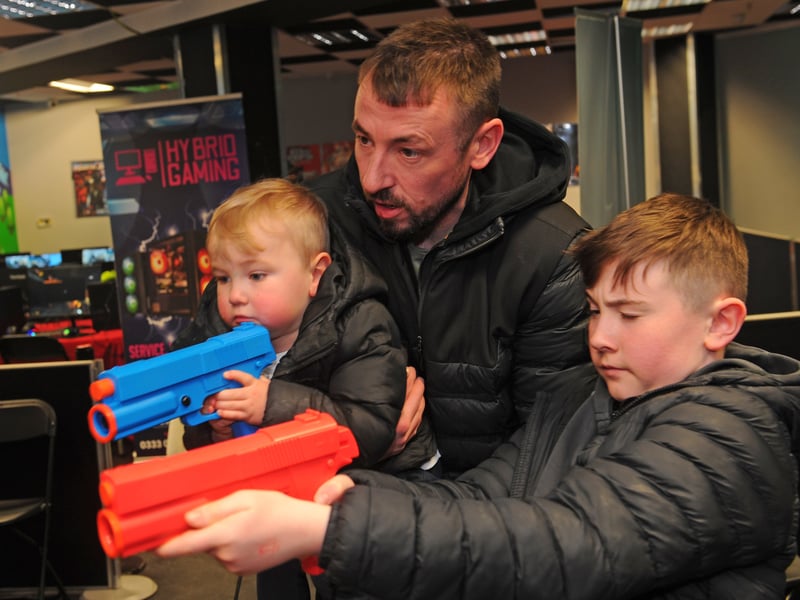 Ross Payne and sons Lachlan, two, and Shaylan, 11, of Halton take aim.
