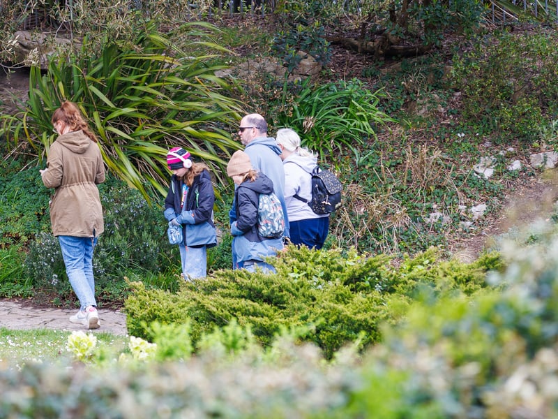 A family enjoys a walk in Southsea while keeping an eye out for any My Dog Sighs artwork.