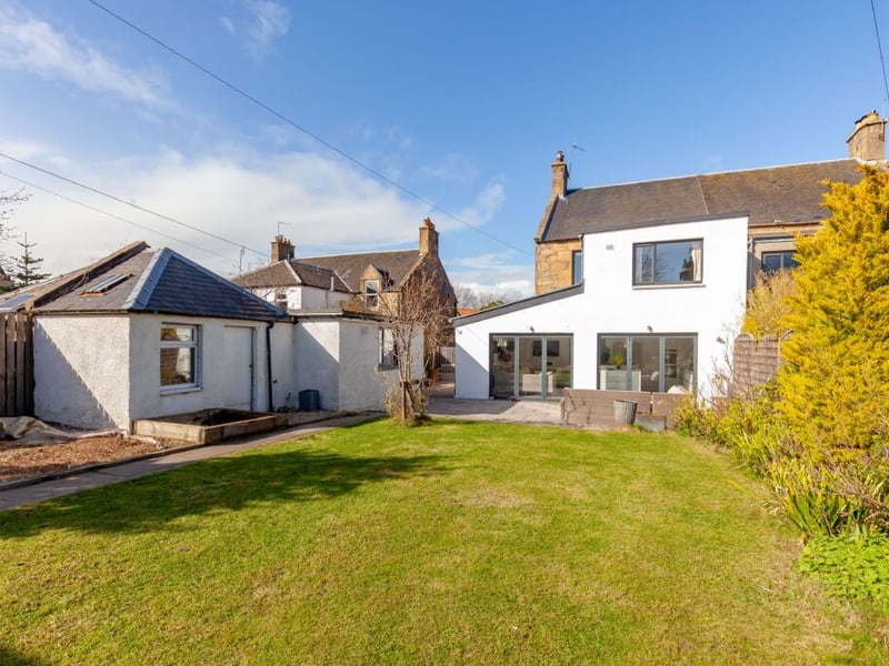 To the rear of the property is a well maintained and fully enclosed south facing garden with patio, and a large summer house.