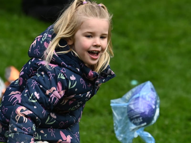 A delighted young lady watches her egg go flying
