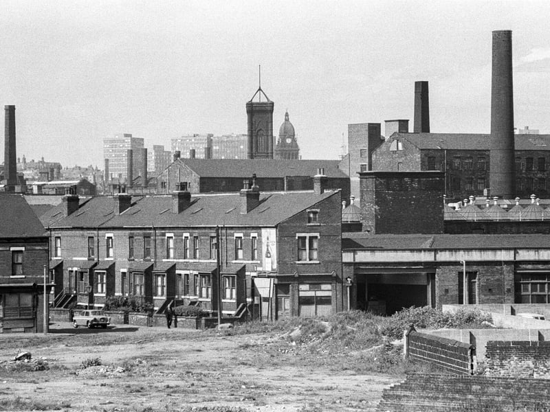 Looking from wasteland on the south side of Sweet Street West towards the junction with Derwent View in the centre in 1969. No. 22 Sweet Street West is at the end of the terrace followed by nos. 2 to 16 Derwent View. On the far left is no. 24 Sweet Steet West. Moving further back are various industrial premises as the view looks towards the city centre. One of the Italianate towers of the Tower Works is seen in the centre with the Town Hall tower beyond this.
